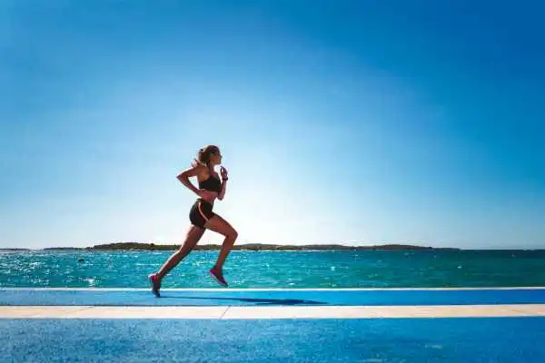 Woman running showing strong leg muscle Falkirk